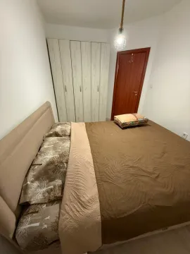 Bedroom with a double bed, wardrobe, and wooden doors. - image 7