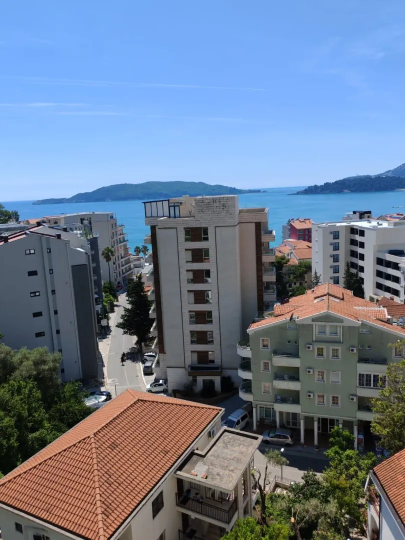 View of city buildings and the sea from the terrace.