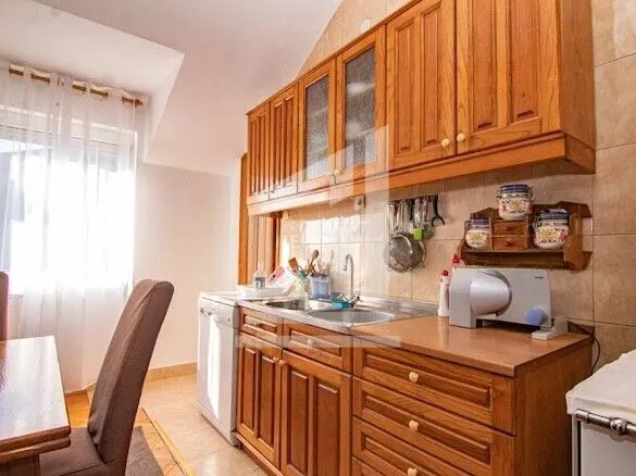 Kitchen with wooden cabinetry and a dining table.