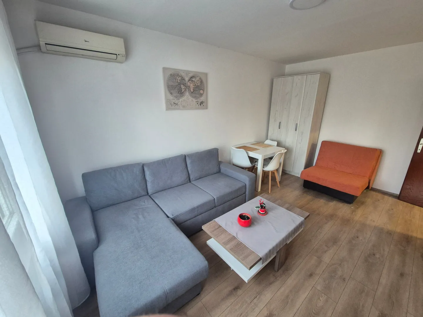 Living room with a sectional sofa, coffee table, and dining area.