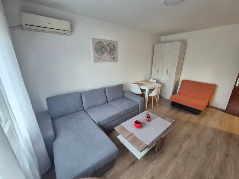 Living room with a sectional sofa, coffee table, and dining area. - image 3