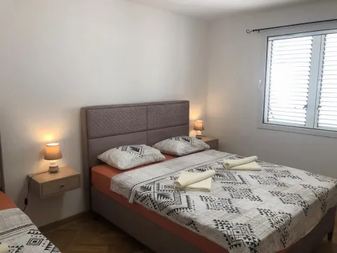 Bedroom with a double bed, bedside tables and a window. - image 8