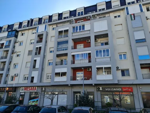 Facade of a modern residential building with commercial spaces on the ground floor. - image 2