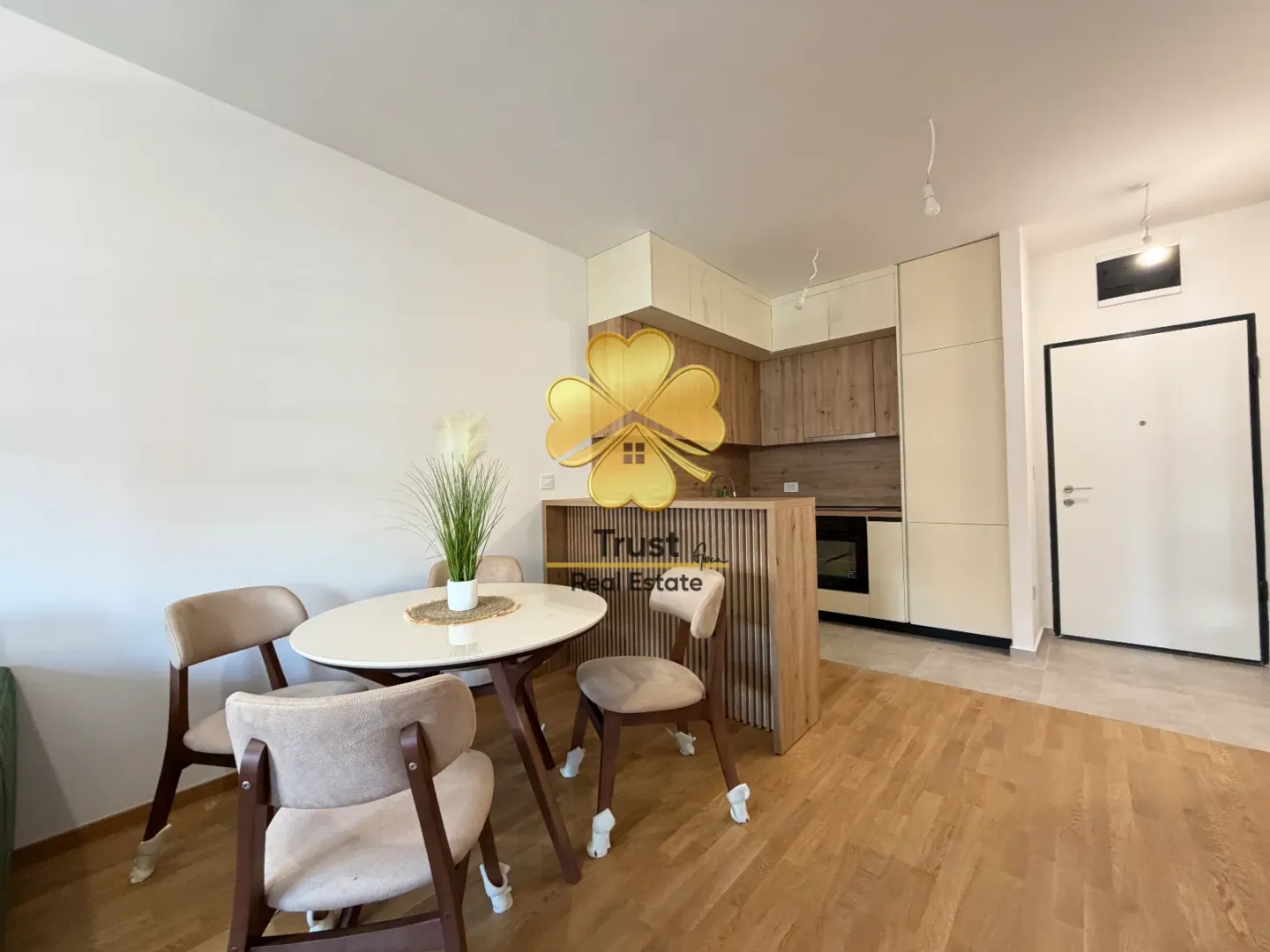 Modern kitchen with dining area and built-in appliances.