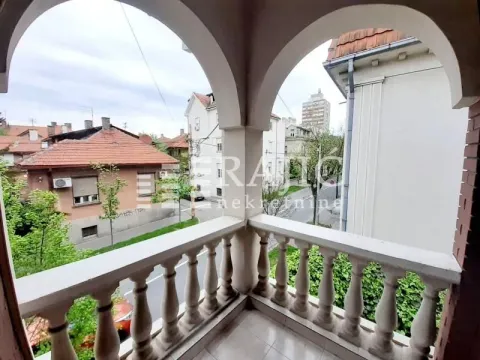 Covered balcony with columns and a view of the street and surrounding buildings. - image 6