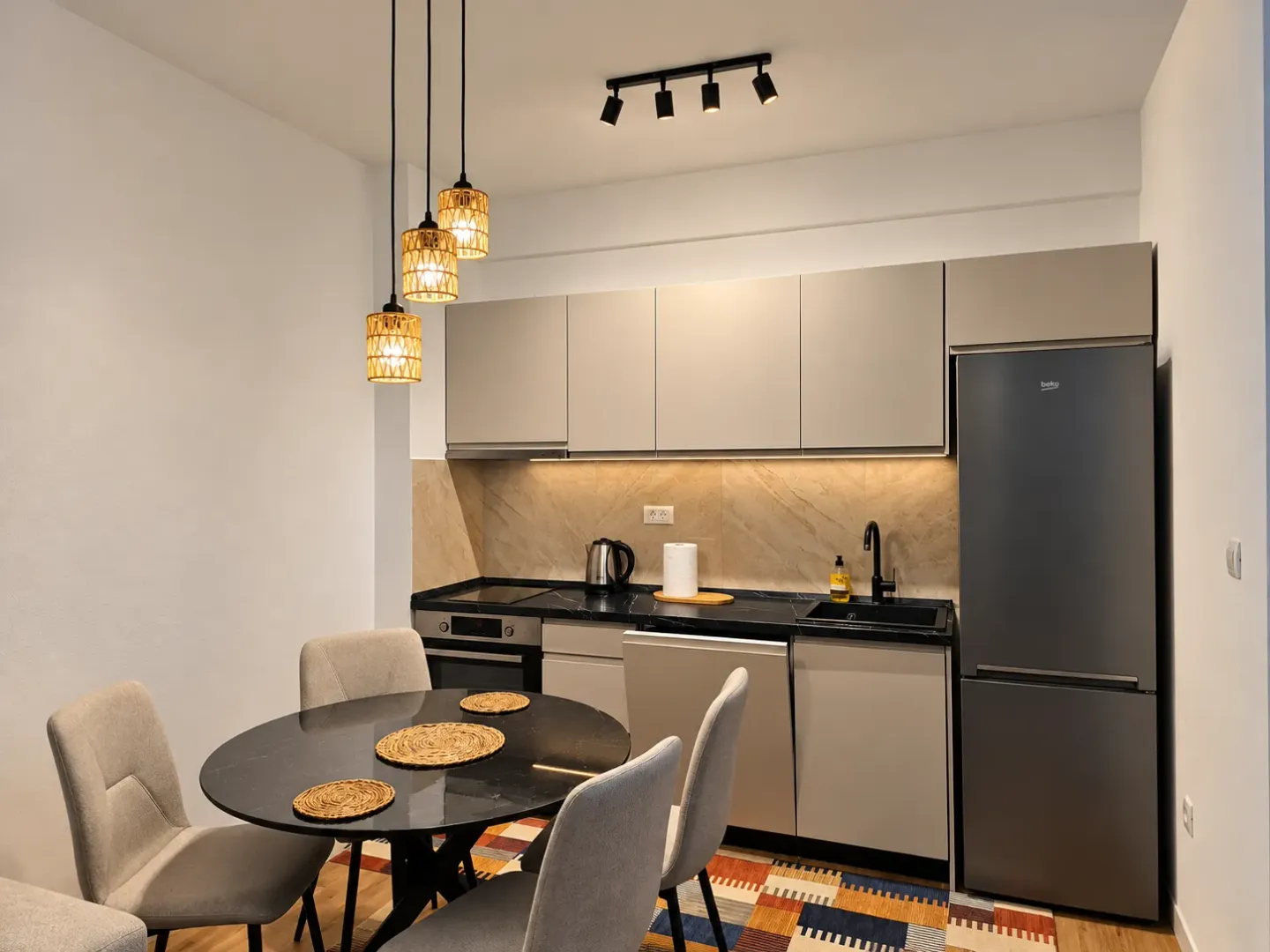 Modern kitchen with a dining table and built-in appliances.
