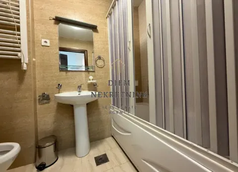 Small bathroom with a sink, mirror, and shower cabin. - image 11