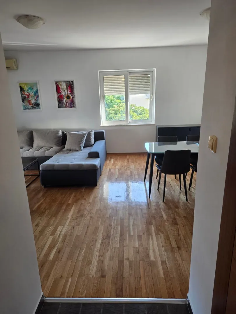 Living room with a sofa and a dining table.