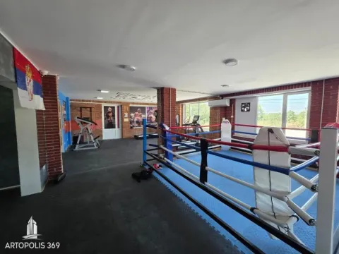 Spacious gym hall with a boxing ring and exercise equipment. - image 3