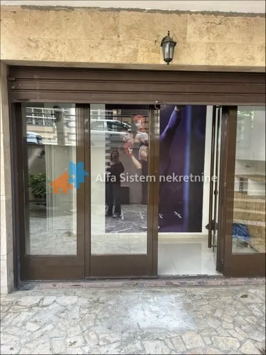 Entrance to the commercial space with glass doors and storefront.