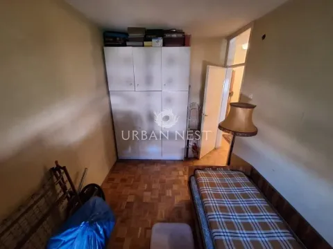 Smaller bedroom with a bed, wardrobe, and parquet flooring. - image 7