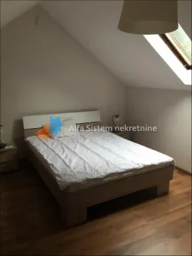 Attic bedroom with a double bed and a roof window. - image 12