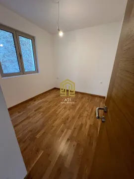 Empty room with hardwood floors and a window. - image 4