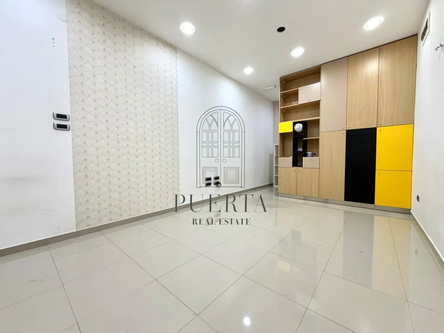 Empty room with a built-in wardrobe and ceramic tile flooring.
