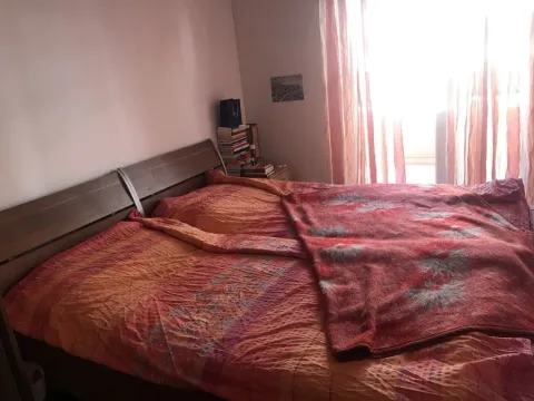 A simple bedroom featuring a large double bed. - image 12