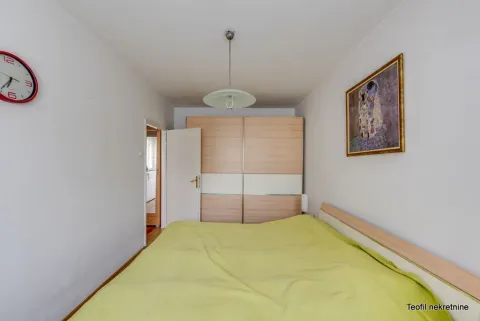 Bedroom with a double bed, large wardrobe, and wall clock. - image 7