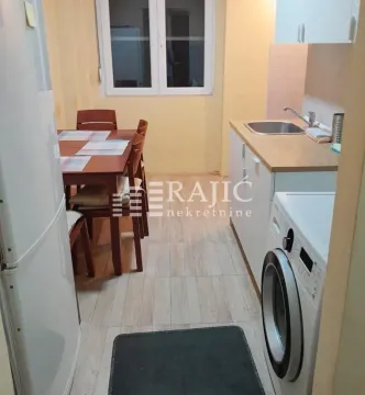 Kitchen with dining area and fitted cabinets. - image 3