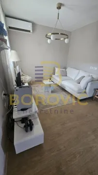 Living room with sofa, coffee table and TV unit. - image 2