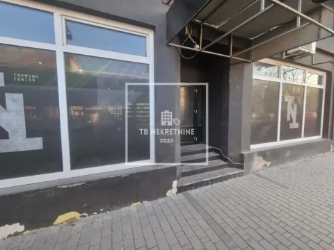 Exterior view of the commercial space with an entrance and large display windows. - image 11