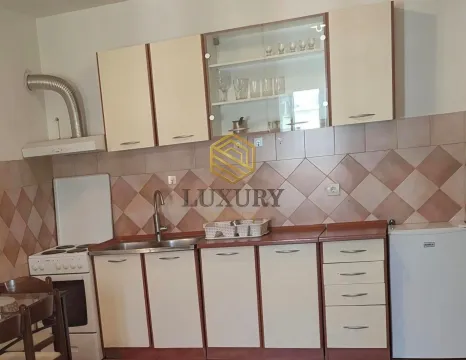 Smaller kitchen with light-colored cabinets and a built-in stove. - image 4