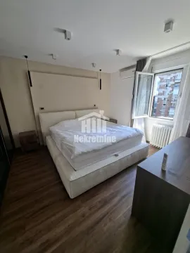 Spacious bedroom with a large double bed and nightstands. - image 7