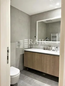 Modern bathroom equipped with a washbasin and toilet. - image 12