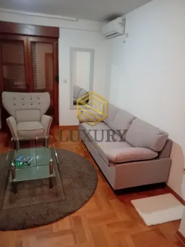 Living room with a sofa, armchair, and coffee table. - image 3