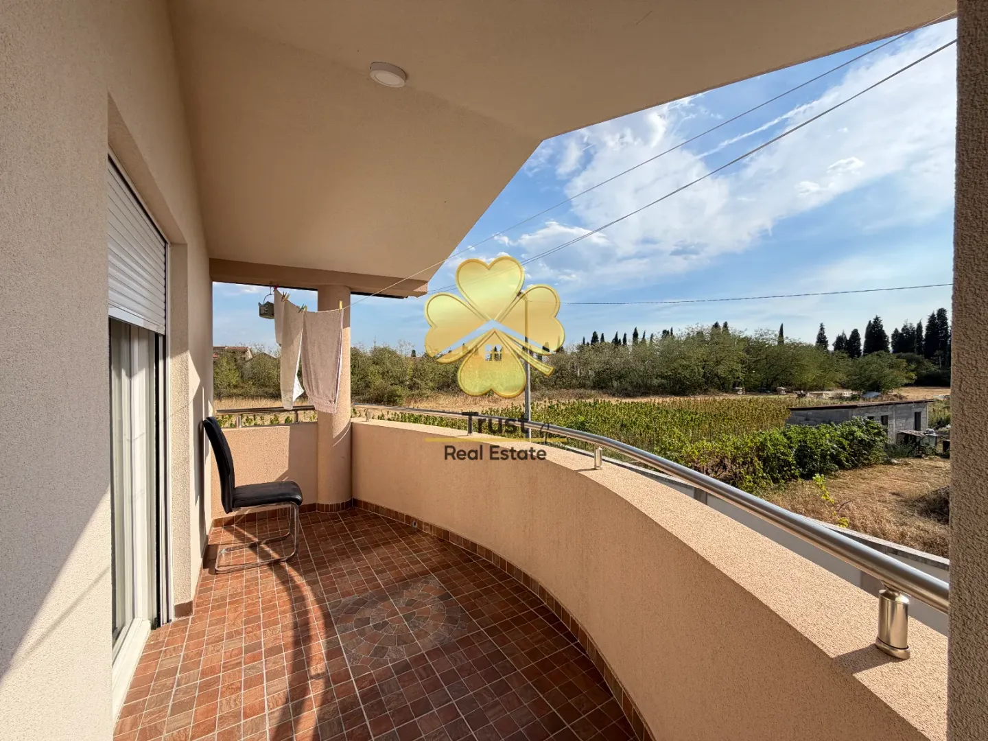 Spacious tiled terrace with a nature view.