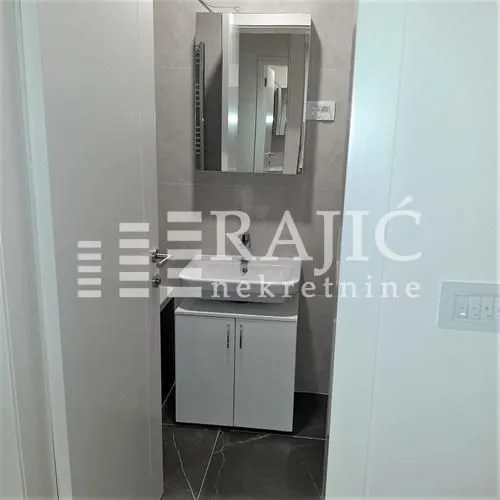 View of the bathroom with a sink and mirror.