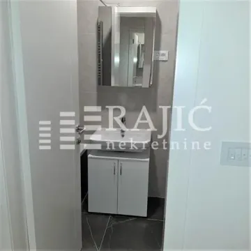 View of the bathroom with a sink and mirror. - image 12