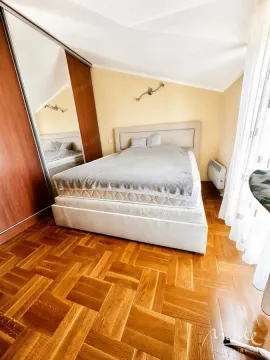 Bedroom with a double bed, wooden parquet flooring, and a large built-in wardrobe. - image 5