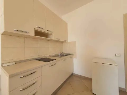 Manja kuhinja u bež tonovima sa ugradnim elementima i frižiderom. - image 3