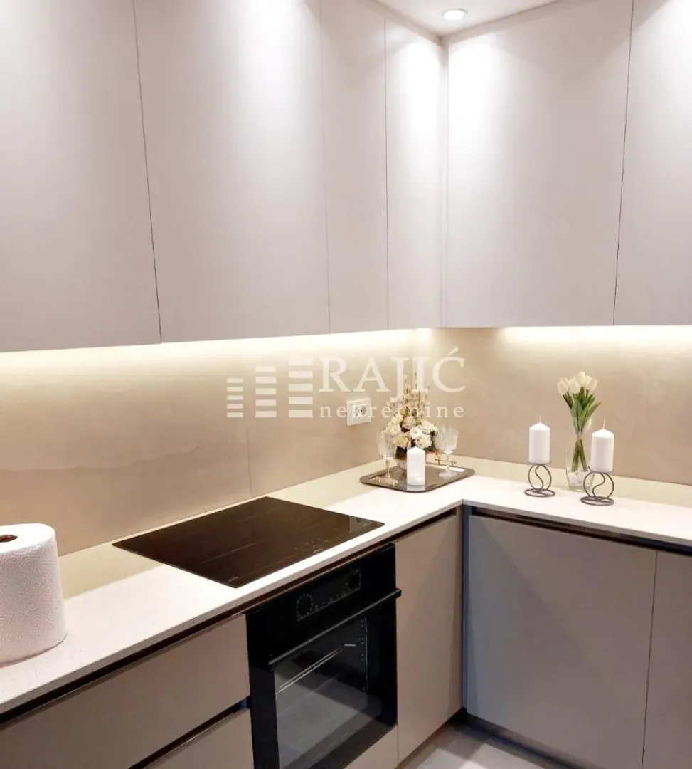 Modern kitchen with a built-in cooktop and cabinetry.