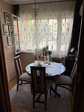 Dining area with a round table, chairs, and a window. - image 5