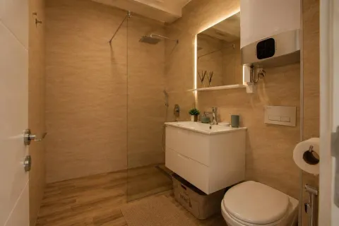 Modernly equipped bathroom with a walk-in shower and a vanity unit. - image 8