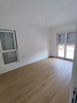 Empty bright room with hardwood flooring and windows with roller shutters. - image 14
