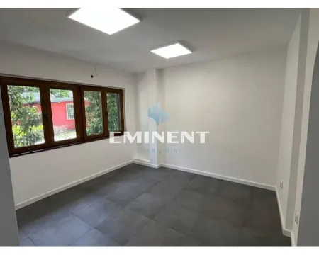 Empty room with dark floor tiles and wooden window frames. - image 4