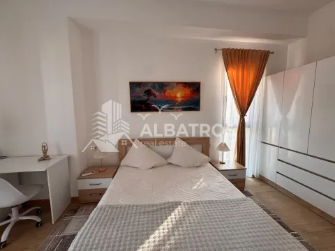 Furnished bedroom with a double bed, wardrobe, and desk. - image 7