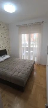 Bright bedroom with a double bed and access to a balcony. - image 28
