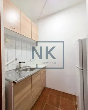 Smaller kitchen with wooden elements and a sink. - image 6