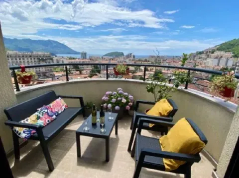 Furnished terrace with seating furniture and a view of the city and sea. - image 8