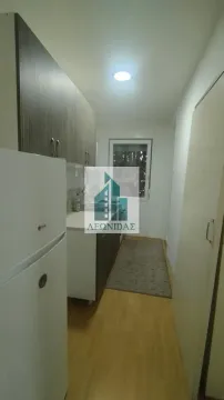 Small narrow kitchen with a white refrigerator and cabinetry. - image 5
