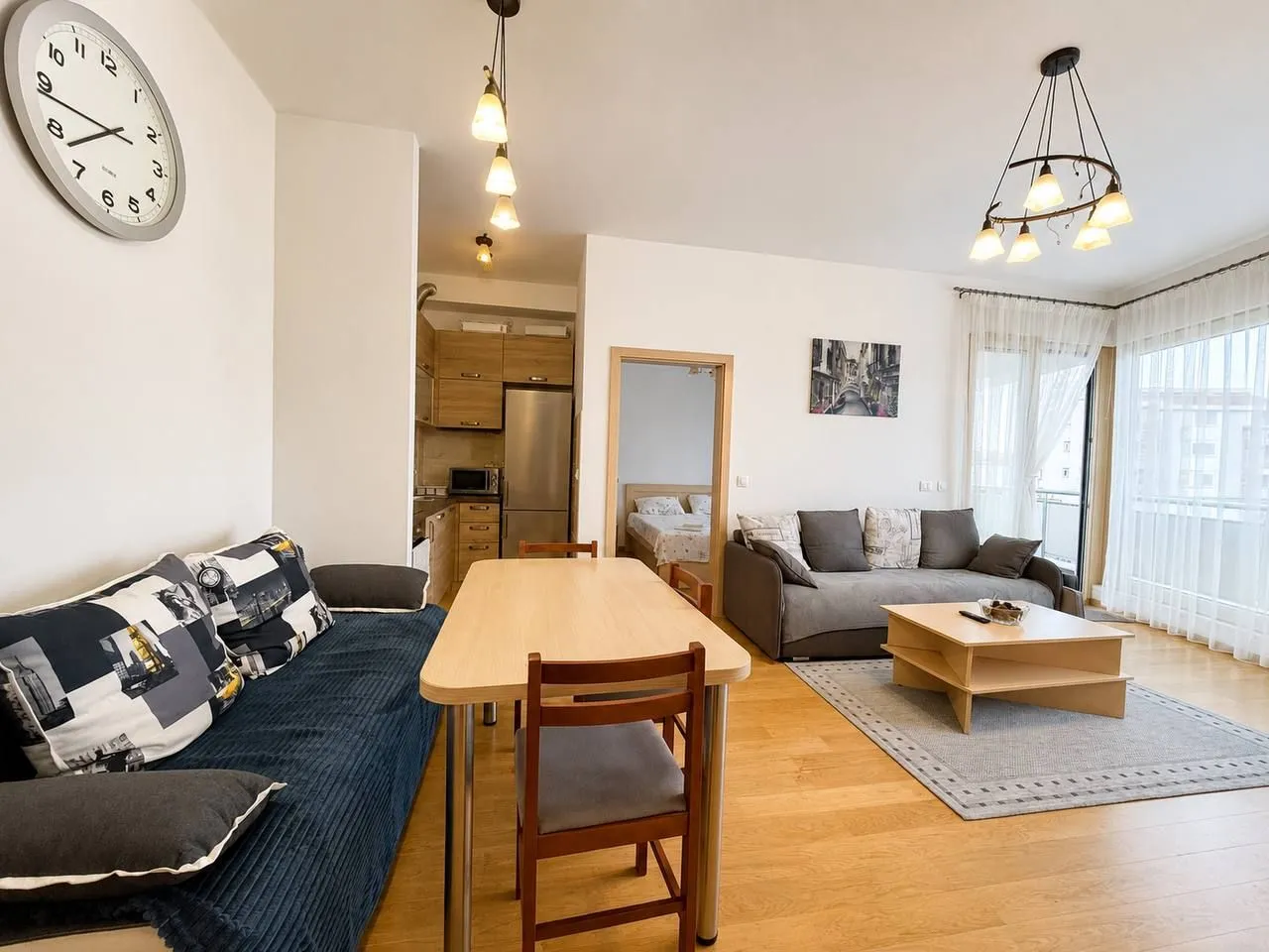 Spacious living room with a dining area and kitchen in the background.