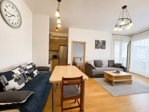Spacious living room with a dining area and kitchen in the background. - image 3