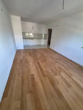 Empty room with wooden flooring and white walls. - image 12