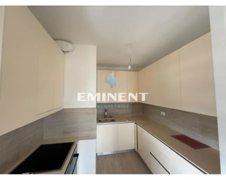 Kitchen with light cabinets and built-in sink. - image 4