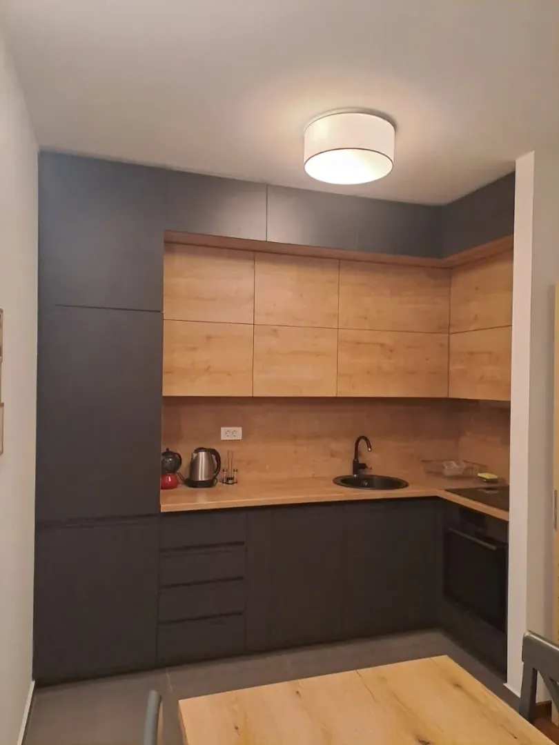 Modern dark-toned kitchen with wooden elements.