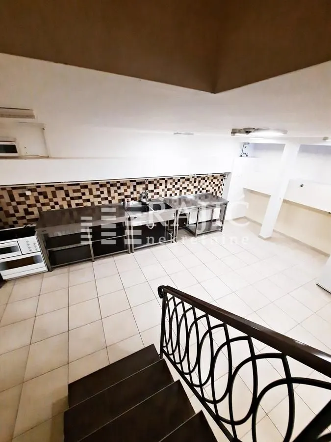 High-angle view of a kitchen with metal units and tiled flooring.