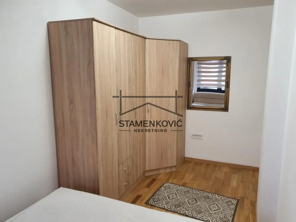 Bedroom with a large wooden wardrobe and bed.