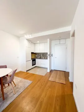 Small white kitchen as part of an open space with a dining area and hallway. - image 3